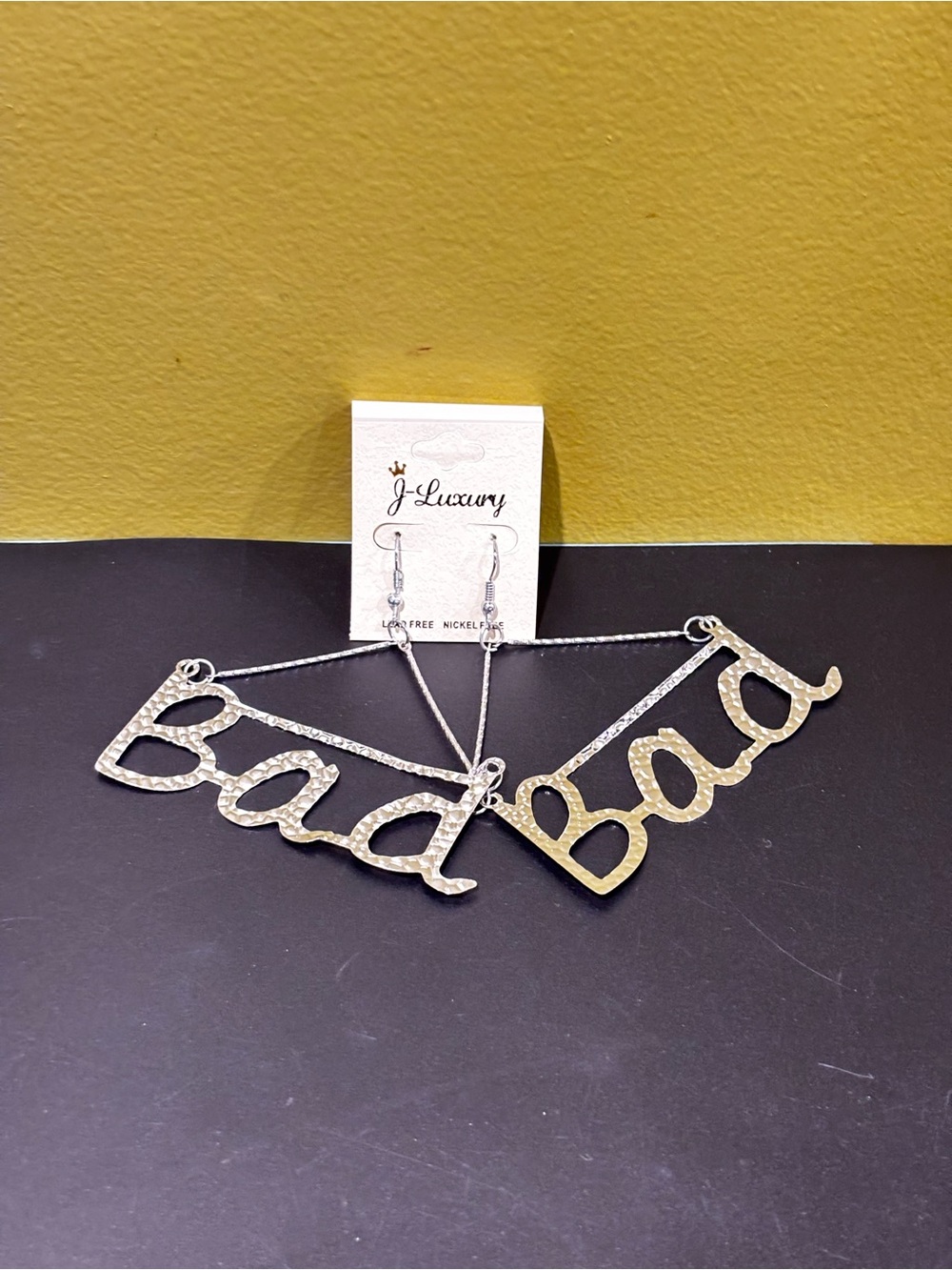 'Bad script Pendant earrings Silver tone